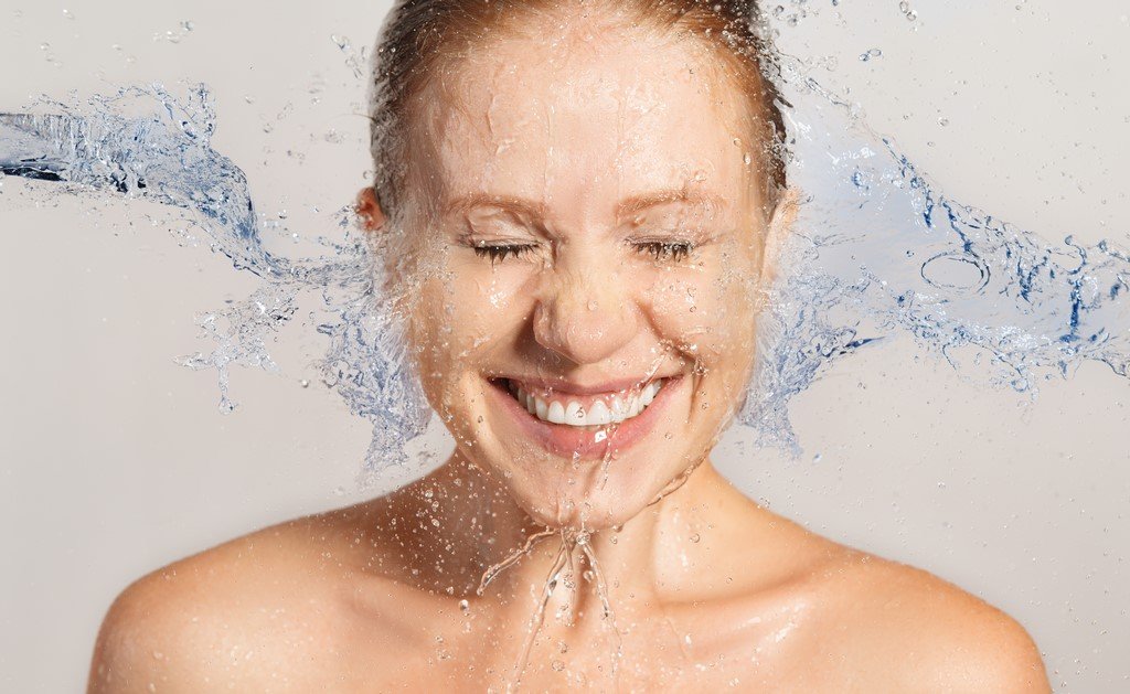 Happy beauty woman skin care, washing with splashes of water